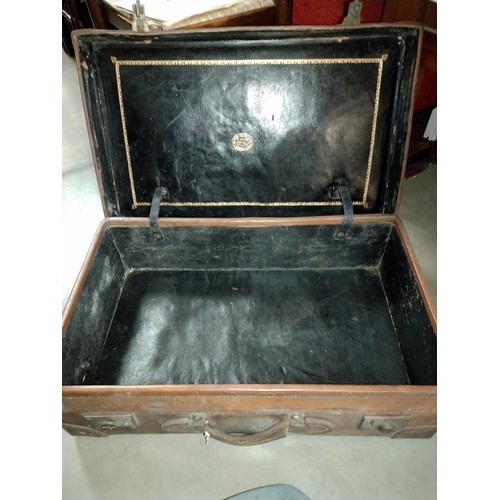 197 - A large early leather suitcase (missing brass plaque on lid)