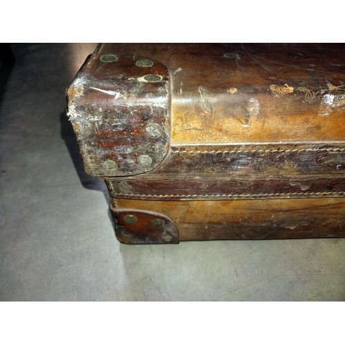 197 - A large early leather suitcase (missing brass plaque on lid)