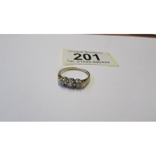 201 - A 9ct gold three stone ring, size K.