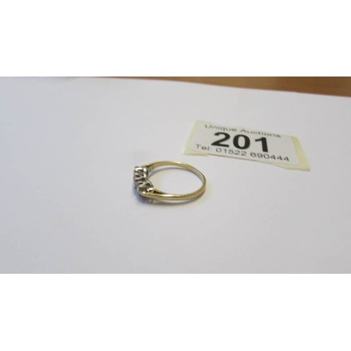 201 - A 9ct gold three stone ring, size K.