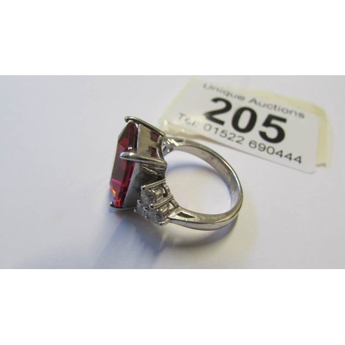 205 - A silver ring set large pale ruby coloured stone, size O.