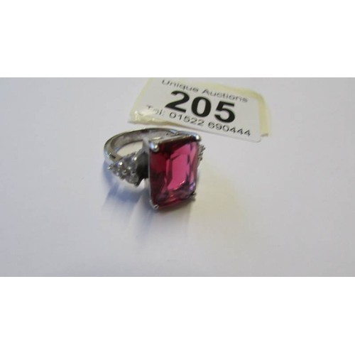 205 - A silver ring set large pale ruby coloured stone, size O.