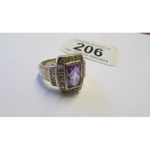 206 - A silver ring with amethyst coloured stone, size R.