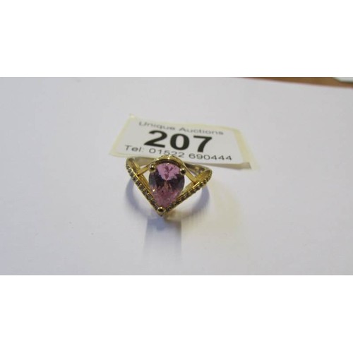 207 - A silver ring with pale pink heart shaped stone, size P.