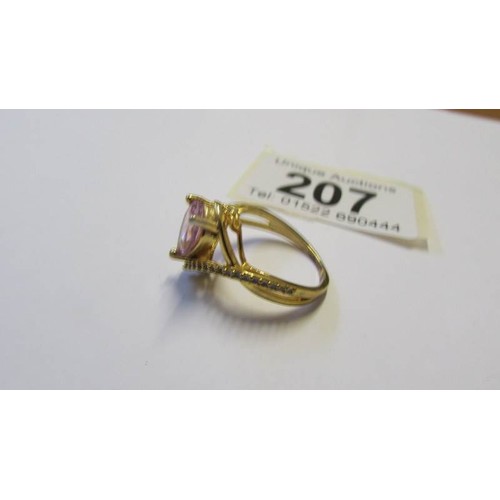 207 - A silver ring with pale pink heart shaped stone, size P.