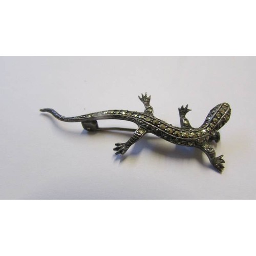 211 - A marcasite lizard brooch in good condition and a mid 20C marcasite and green stone ring. Size Q,