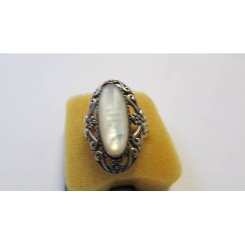 221 - A silver ring set oval mother of pearl, another silver ring and a cameo brooch.