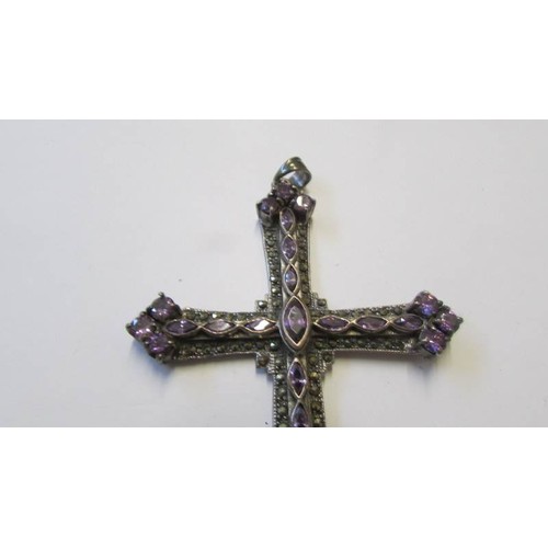 222 - A large silver cross pendant set amethyst coloured stones, 10 cm x 6.6 cm..