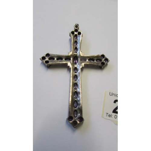 222 - A large silver cross pendant set amethyst coloured stones, 10 cm x 6.6 cm..