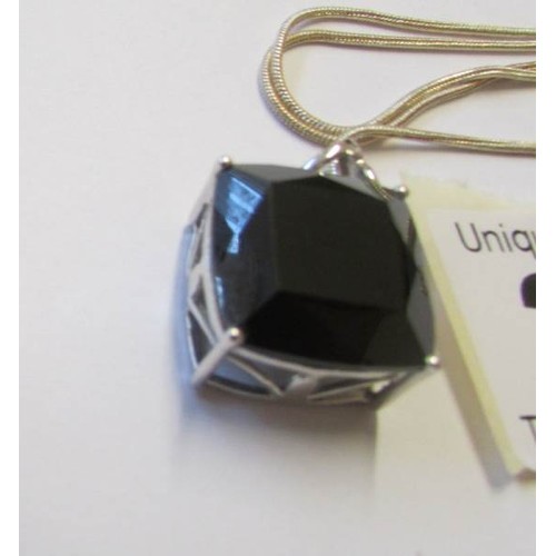 223 - A silver pendant set square black onyx.