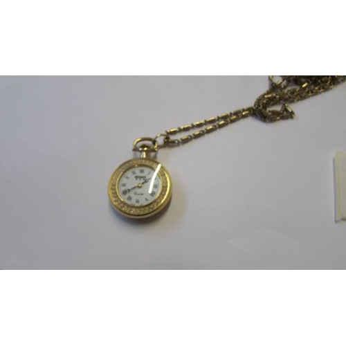 238 - A gilded pendant watch with enamel style back and front, Swiss made, Bernex.  In working order.