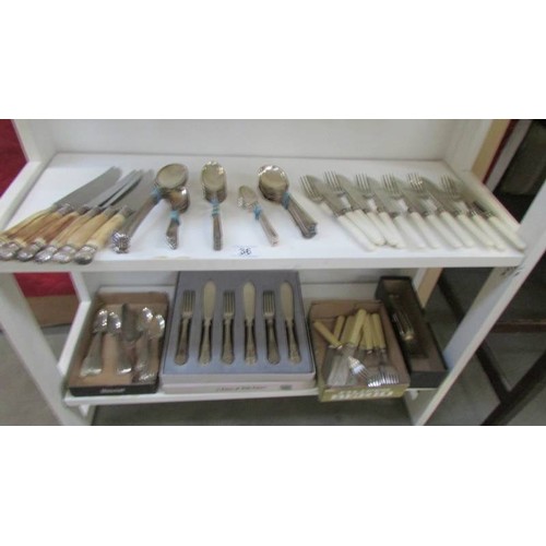 36 - A mixed lot of cutlery including fish knives and forks.