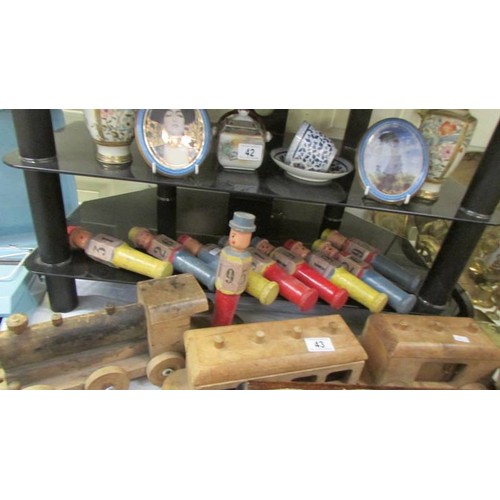 43 - A vintage wooden train and a set of old wooden skittles.