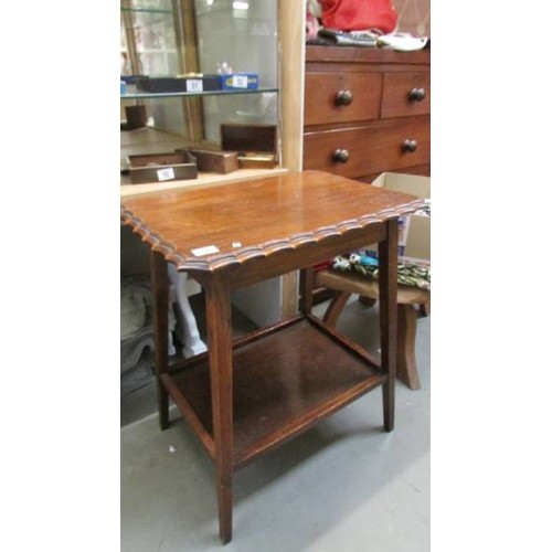 57 - A darkwood table with drawers and glass inset top.