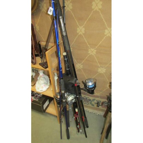 69 - A quantity of fishing rods and three fishing reels, COLLECT ONLY.