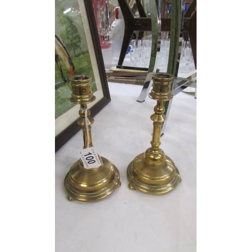 100 - A pair of good quality brass candlesticks.