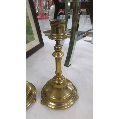 100 - A pair of good quality brass candlesticks.