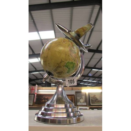 105 - A World globe featuring an air plane.