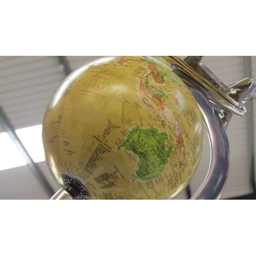 105 - A World globe featuring an air plane.