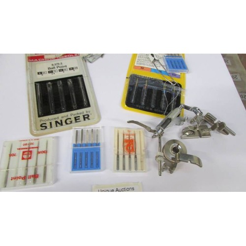 266 - A quantity of sewing machine needles etc.,