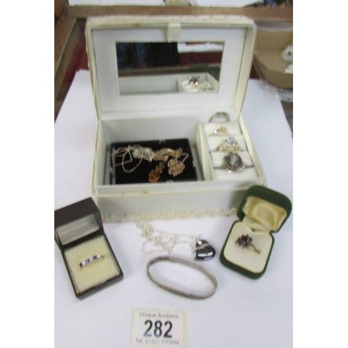 282 - A jewellery box containing three pendants and six rings