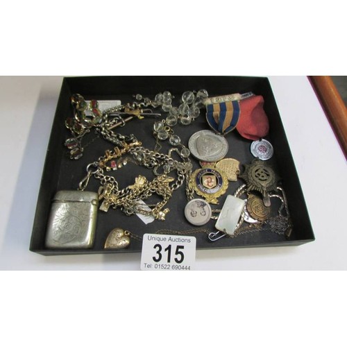 315 - A mixed lot of medals, badges etc.,