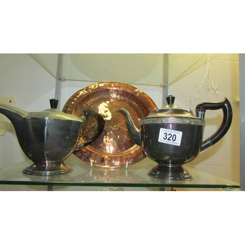 320 - A brass tray and two plated teapots.