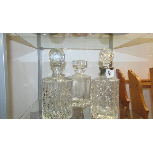 321 - Three cut glass decanters.