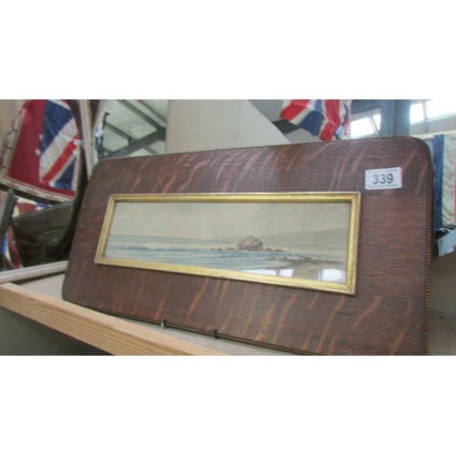 339 - An oak framed and glazed coastal scene. COLLECT ONLY.