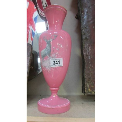 341 - A pink glass vase with stag decoration.