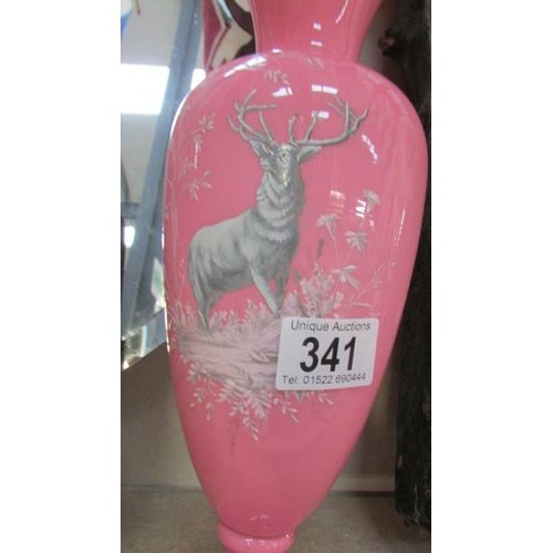 341 - A pink glass vase with stag decoration.