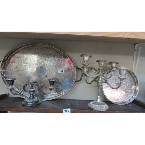 344 - Two silver plate trays and two silver plate candelabra. COLLECT ONLY.