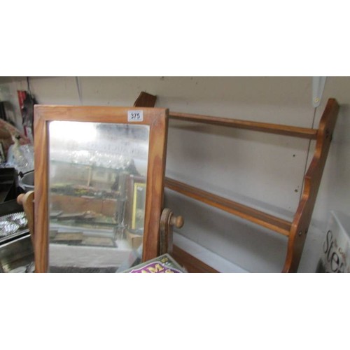 375 - A pine framed toilet mirror and a wall shelf. COLLECT ONLY.