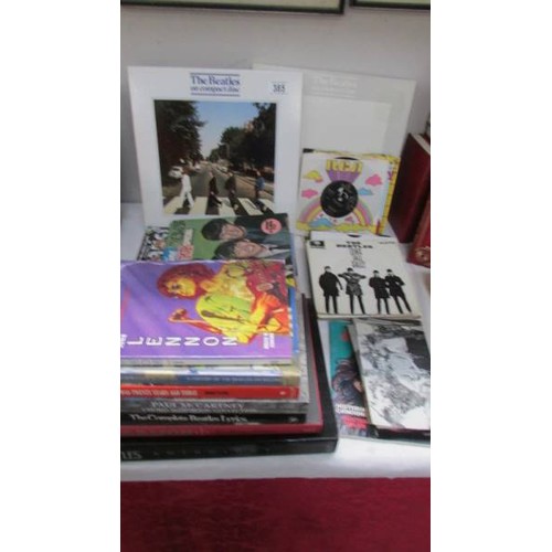 385 - A quantity of Beatles books, singles, CD's etc.,