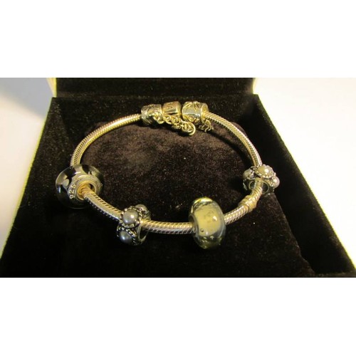 2014 - A Pandora bracelet with four charms.