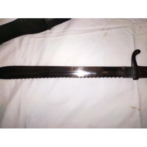 2163 - A German sawback butchers bayonet in scabbard COLLECT ONLY