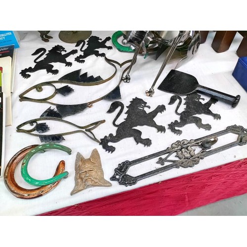 24 - A quantity of metal ware including novelty dog bottle holder, rampant lions & a fish wall bracket