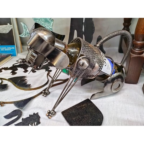 24 - A quantity of metal ware including novelty dog bottle holder, rampant lions & a fish wall bracket