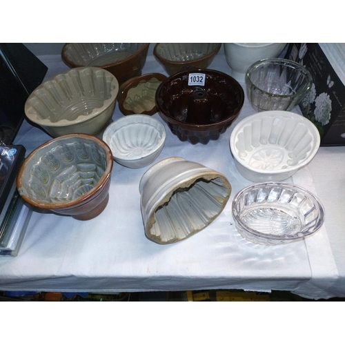 1032 - A collection of 12 glass & ceramic jelly moulds. COLLECT ONLY.