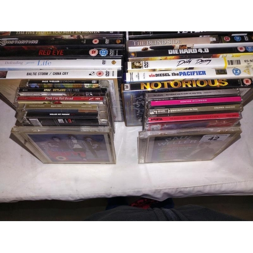 42 - A quantity of DVD's & CD's including Paul Weller etc.