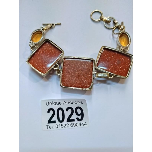 2029 - A gold stone set bracelet in silver