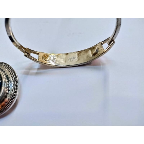 2032 - A Mexican silver bangle & a stone set silver brooch