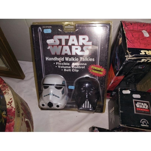 63 - A quantity of vintage Star Wars items all in packaging, includes walkie talkies, alarm clock etc