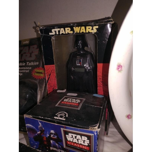 63 - A quantity of vintage Star Wars items all in packaging, includes walkie talkies, alarm clock etc