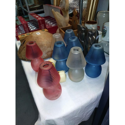 82 - A selection of colourful glass tea light lamps plus a pair of artistic candle holders and 2 candles,... 