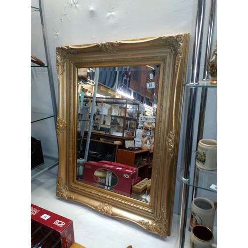 85 - An antique gilt framed bevel edged mirror (chip to frame) 74cm x 94cm, COLLECT ONLY.