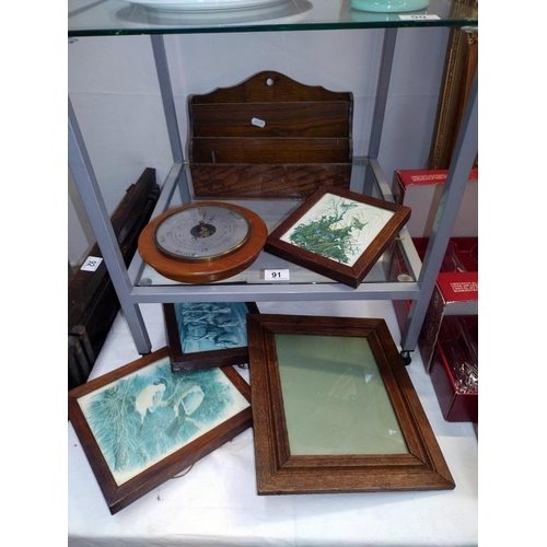 91 - An oak letter rack, selection of oak frames and a barometer