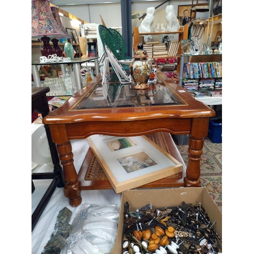 189 - A mahogany coffee table with bevel glass top and bergere panel shelf. 133 cm x 57cm x height 42cm, C... 