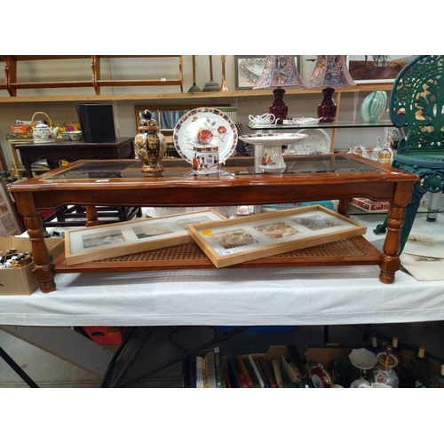 189 - A mahogany coffee table with bevel glass top and bergere panel shelf. 133 cm x 57cm x height 42cm, C... 