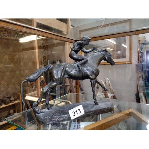 213 - A bronzed resin figure of a Jockey on a racehorse, COLLECT ONLY.